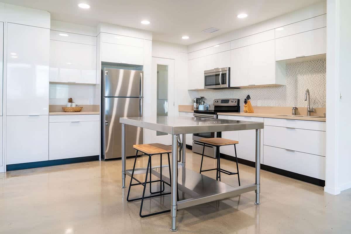 Modern kitchen with metallic epoxy floor white cabinets