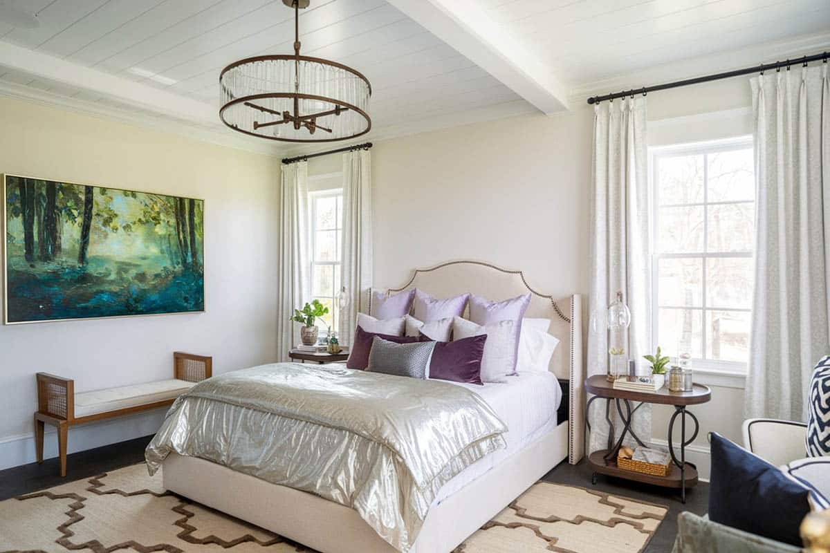 Bedroom with wall art, dark wood floors and globe chandelier
