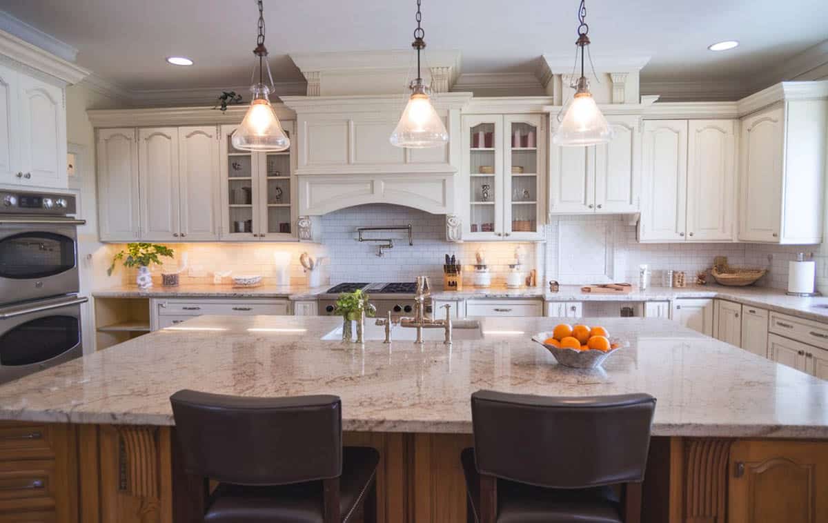 Kitchen with large island with bianco catalina granite and seating