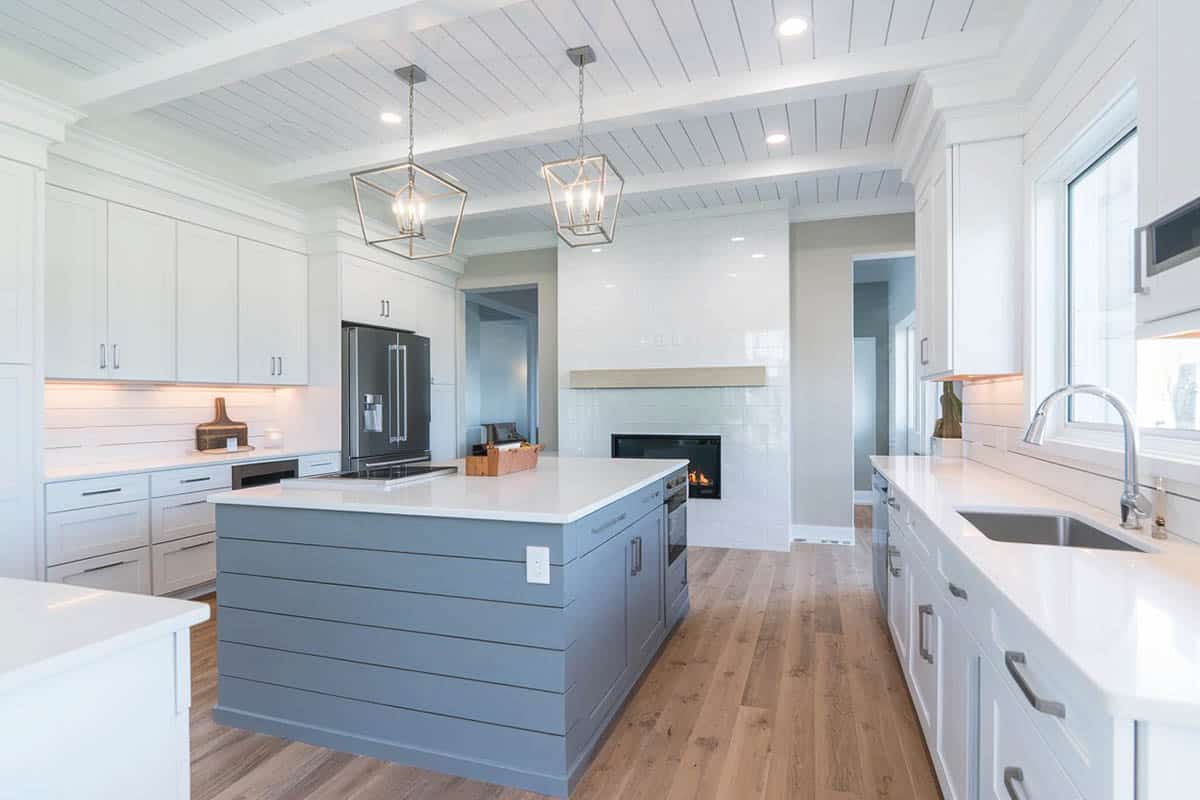 Beautiful kitchen with gray shiplap island and white planking on the ceiling