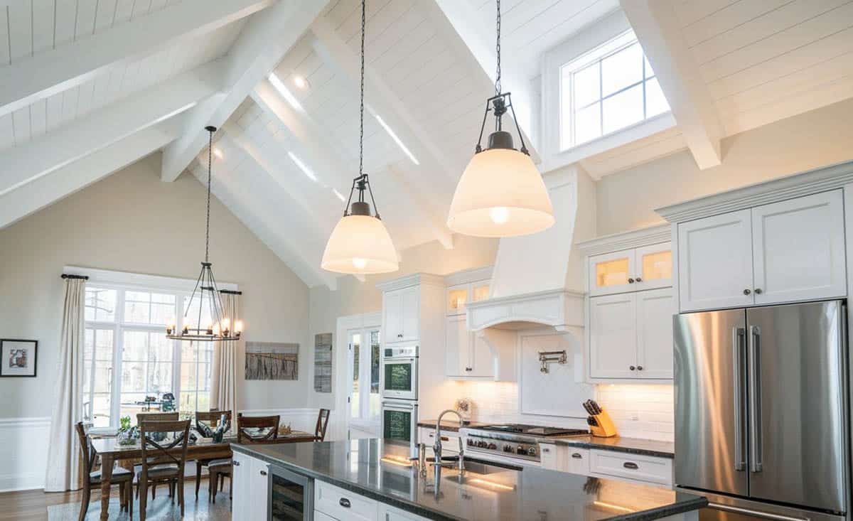 Kitchen with vaulted ceiling and long planks painted white