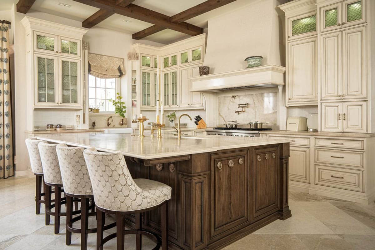 kitchen with bianco carrara for countertops and elegant design with off-white cabinetry and dark island