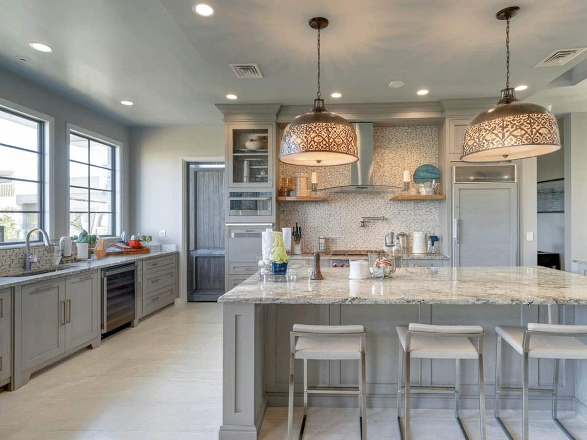 Transitional kitchen with breakfast bar island with river white granite counter and rasmussen bar stool with cushion
