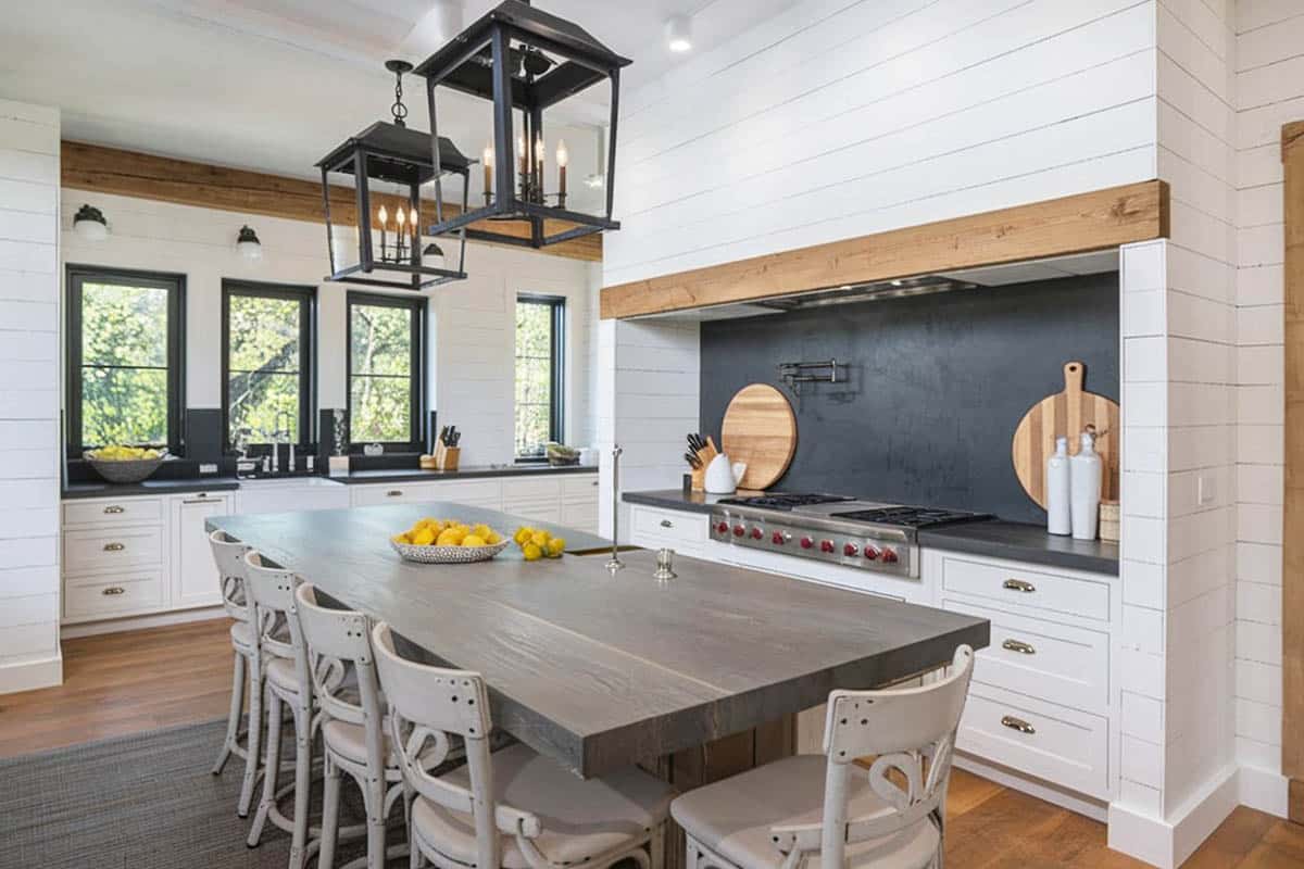 kitchen with wood counter island with soapstone surfaces and five chairs