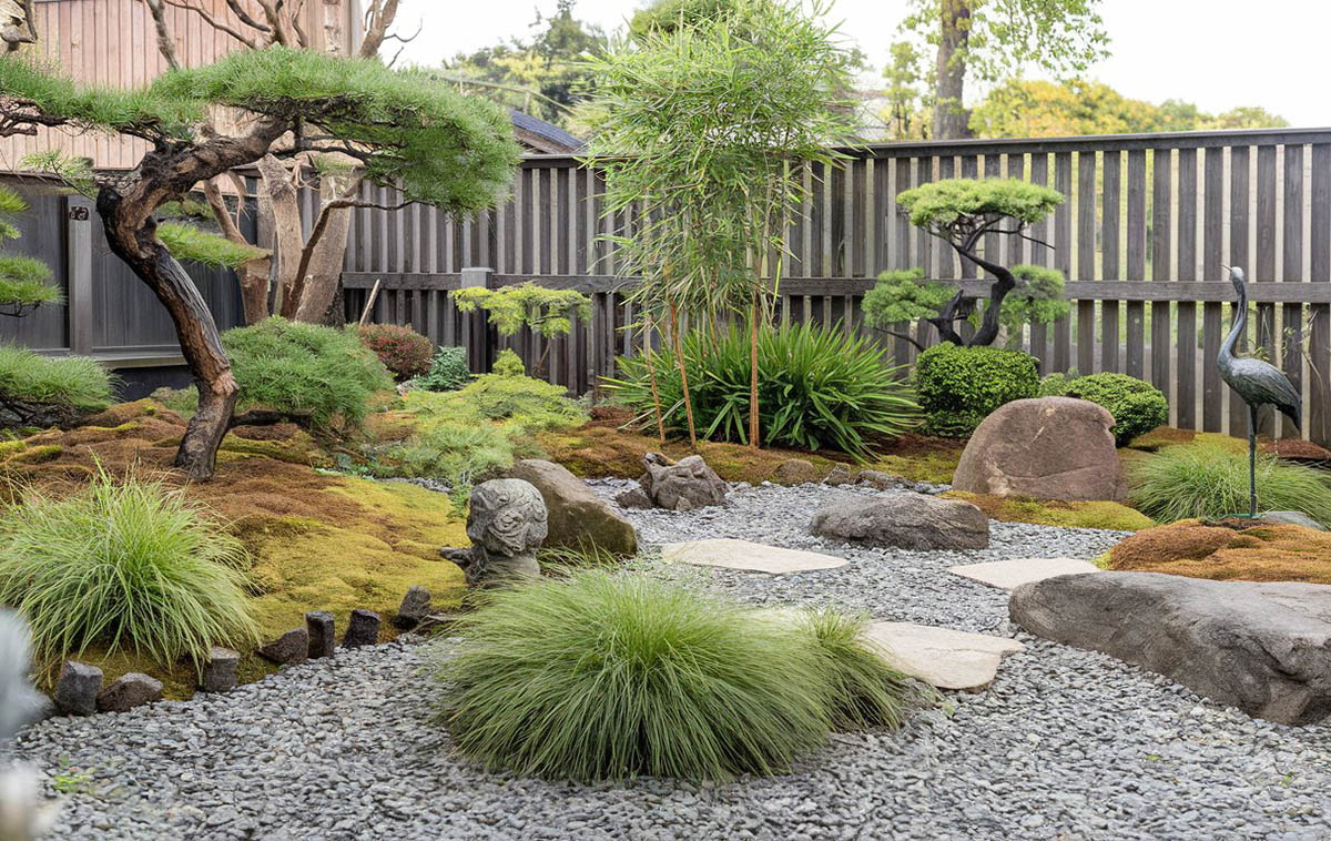 Asian garden with painted vertical wood slat fence