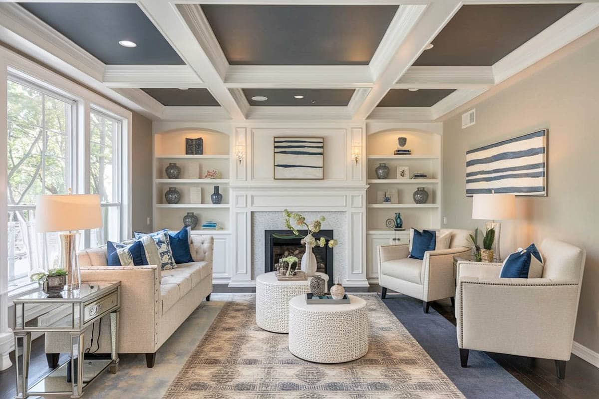 Contemporary living room with box beam ceiling and fireplace with built-in bookshelves