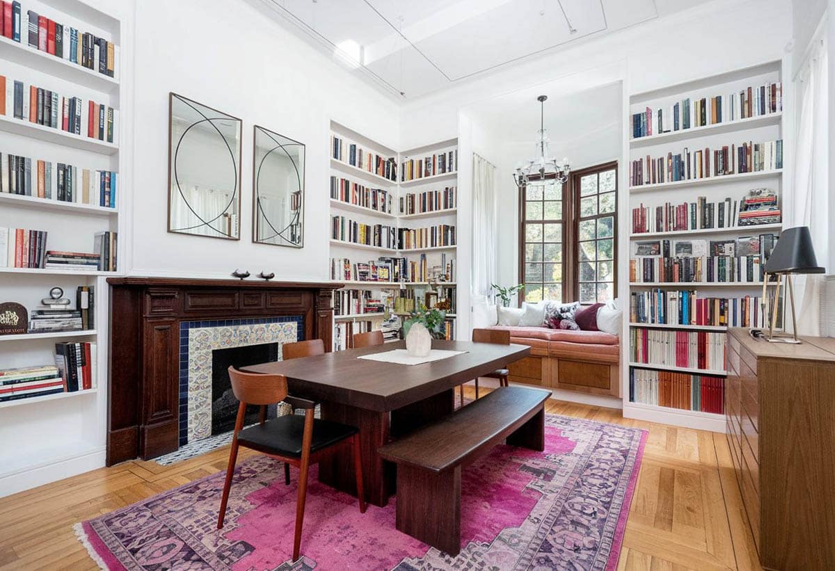 Room with corner shelves, solid wood table and bench with pink carpet