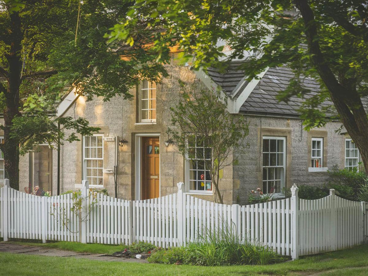 Cottage with curved design pickets and decorative posts