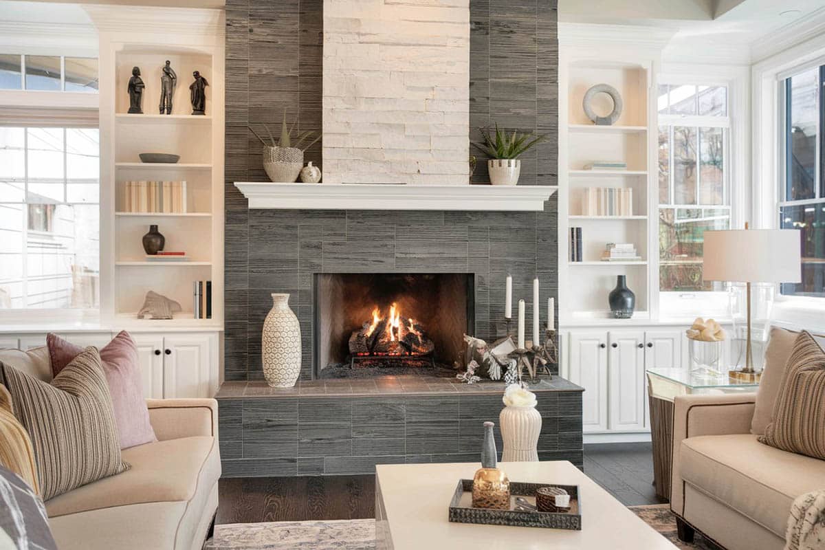 Custom built in cabinets with tile fireplace and taupe couches