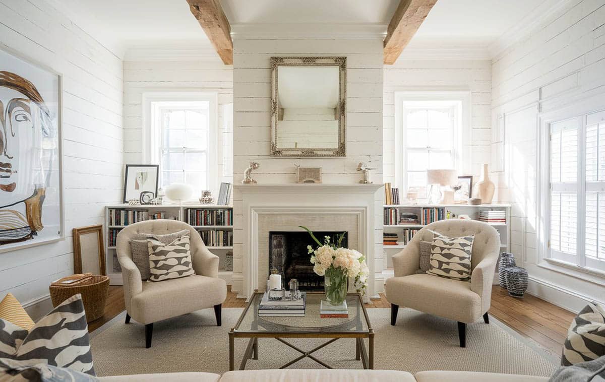 Room with horizontal shiplap walls, wall mirror, bookshelves with accessories on their top