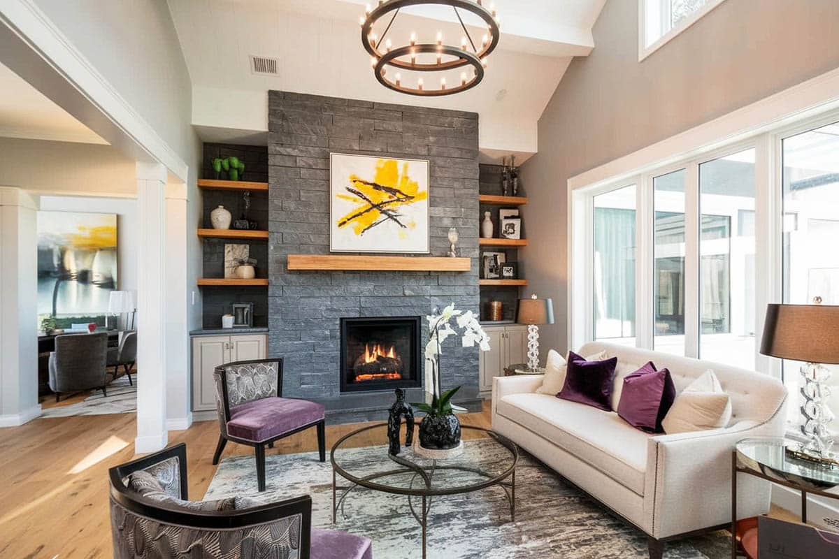 Room with slate fireplace and gray shelves with cabinets