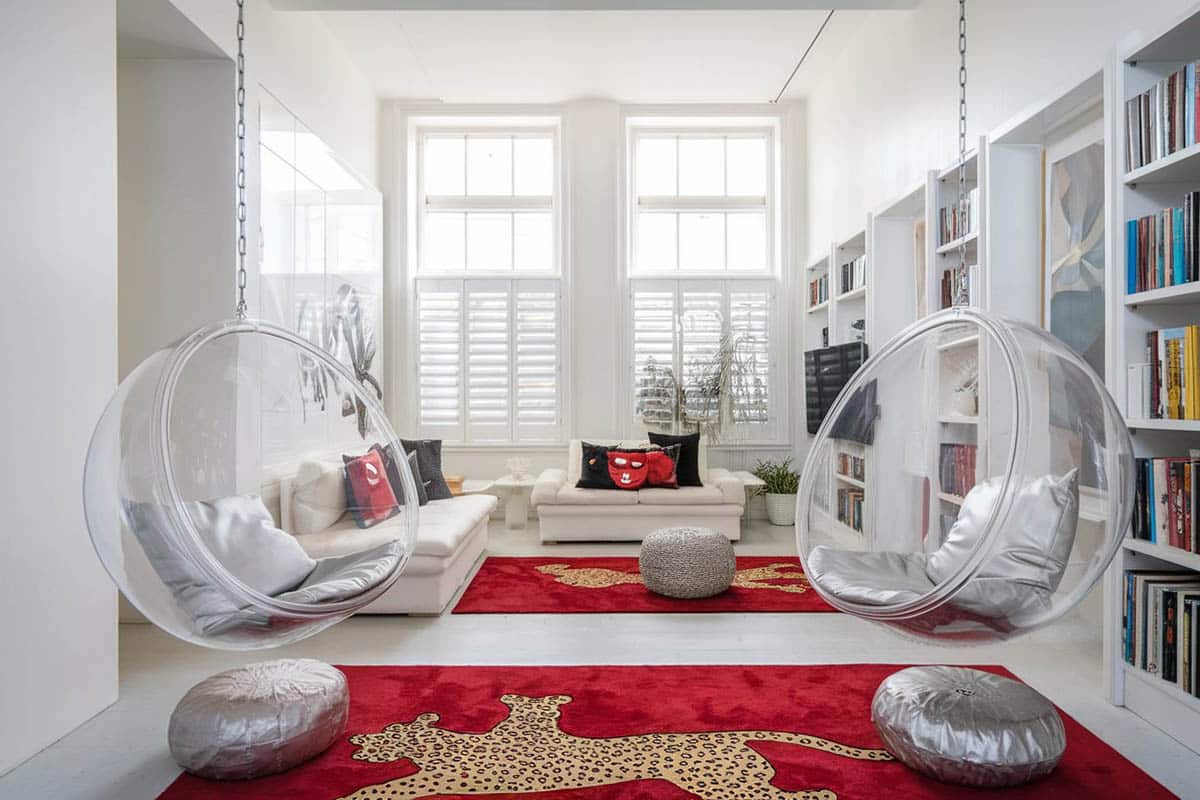 Modern living room with two round cocoon hanging chairs