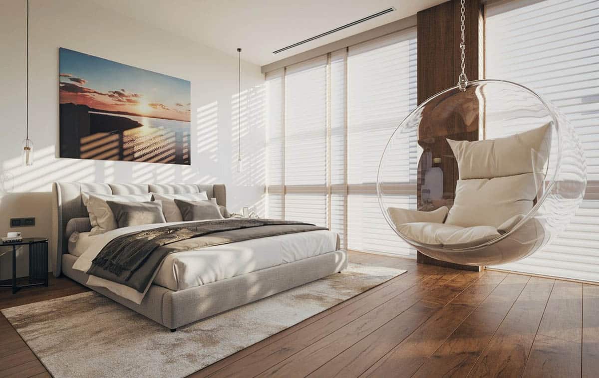Modern master bedroom with clear cocoon style chair