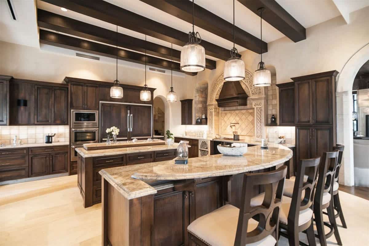 Kitchen with raised breakfast bar. white walls and cabinets made of wood with dark finish