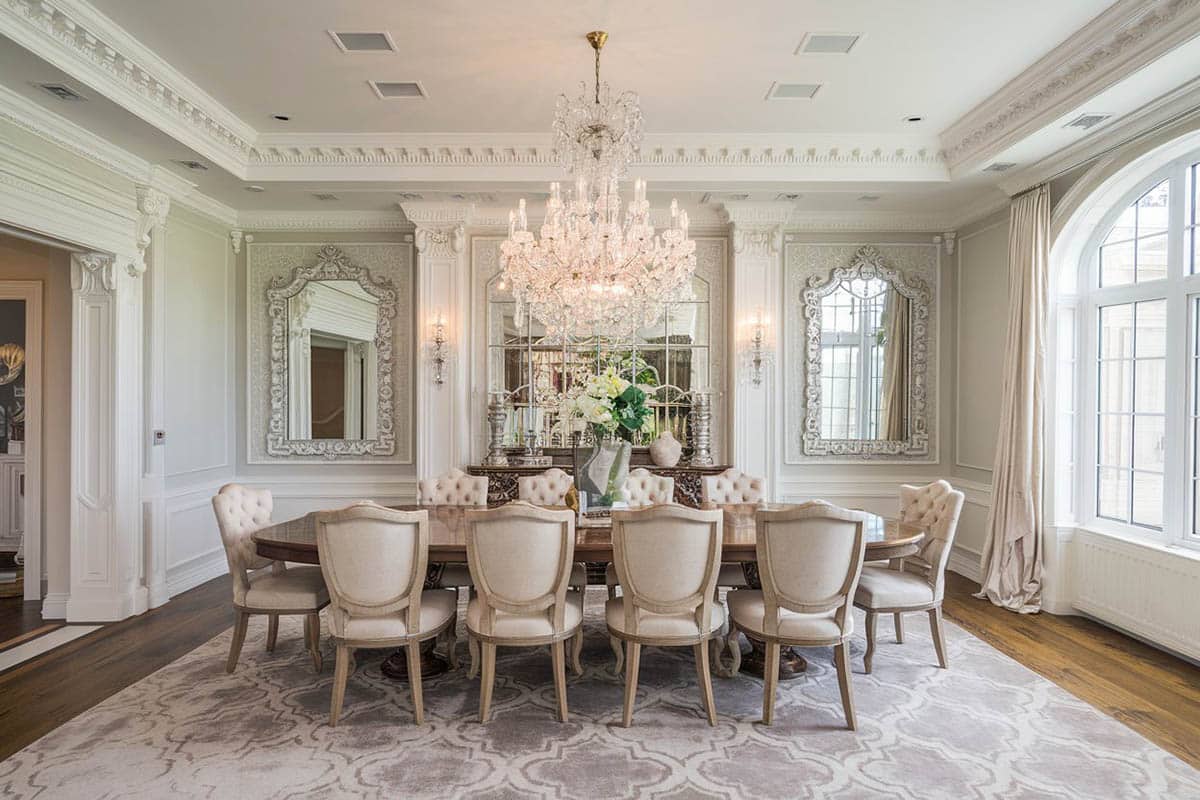 Elegant gray formal dining room with wainscoting and crystal chandelier