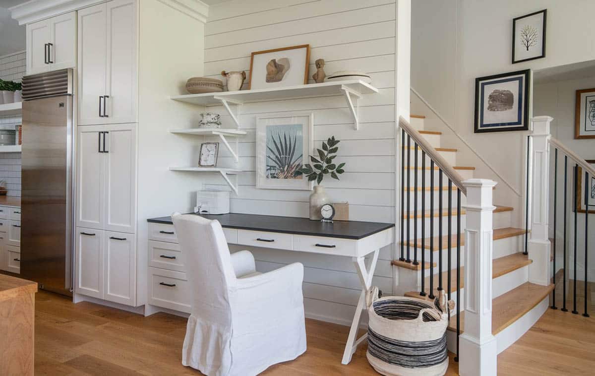 Kitchen office nook with built in desk with drawer storage in black and white tones