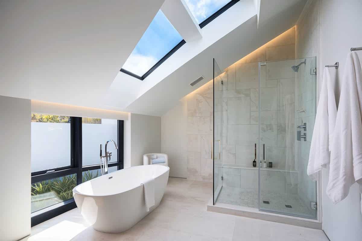 Modern white bathroom with large shower with rainfall showerhead