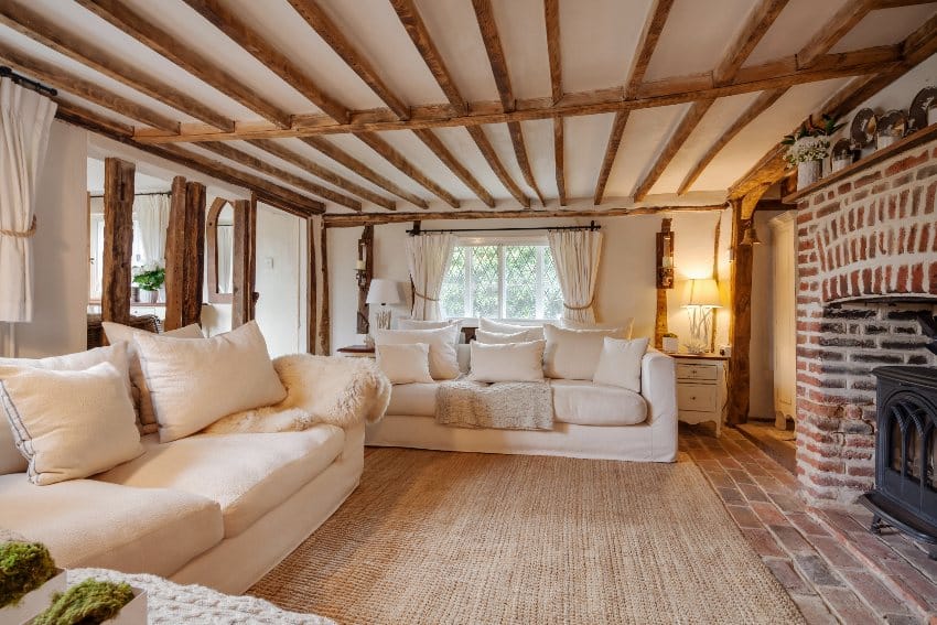 Interior with exposed wood beams on the ceiling and brick fireplace