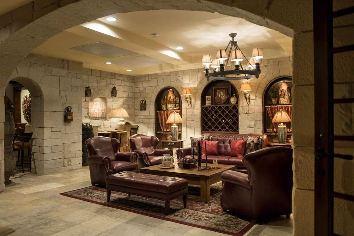 Basement lounge with custom stone walls and wine racks