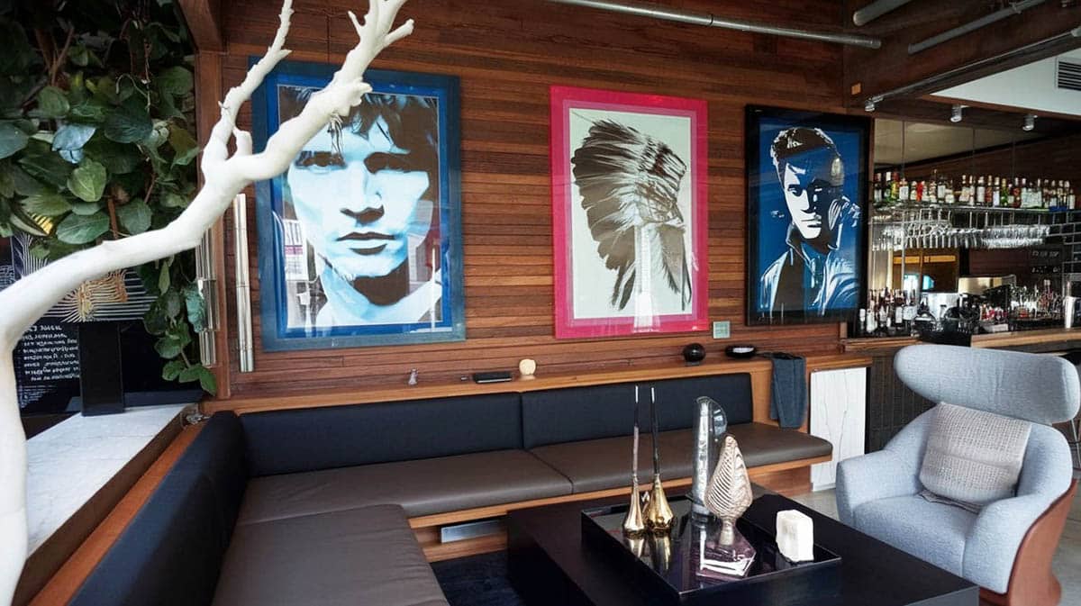 Celebrity art decor with stocked bar and bench seating