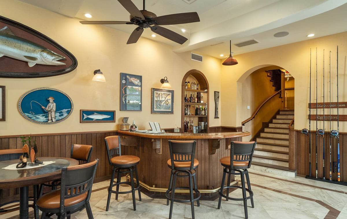 Fishing themed basement with rods, fish decor and bar