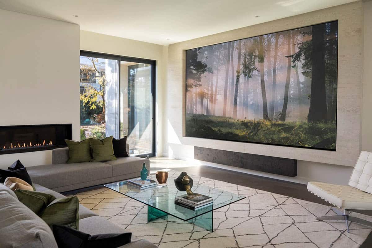 Lounge area for watching movies with modern sofa next to gas fireplace