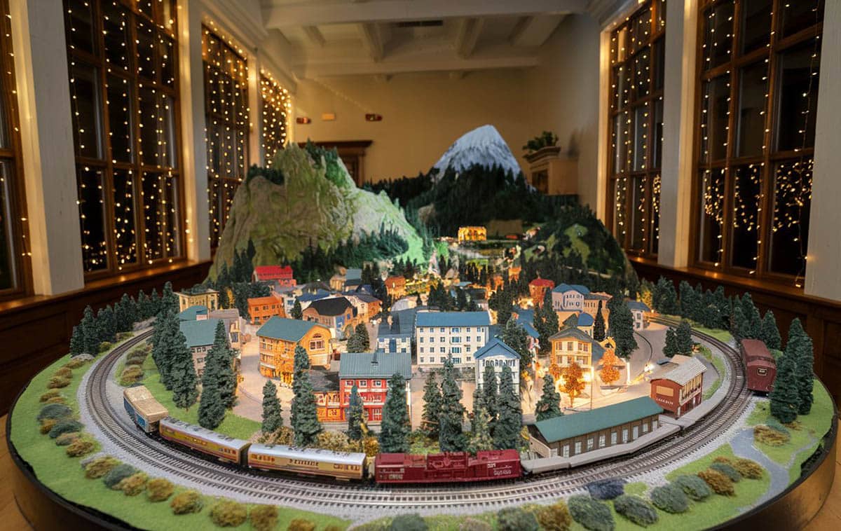 Model train room with forest and town landscape